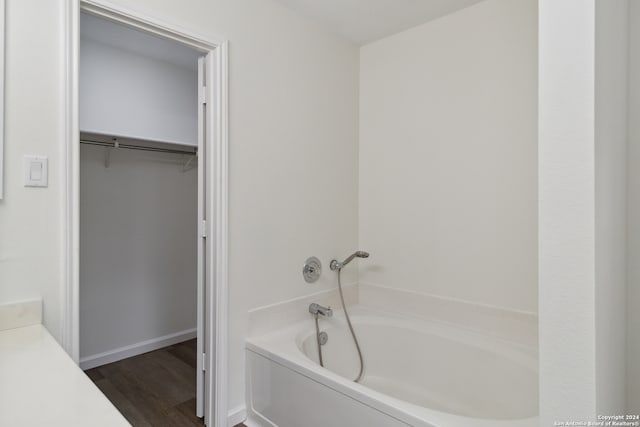 bathroom featuring hardwood / wood-style floors and a tub