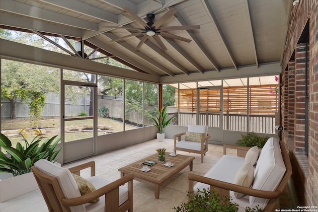 sunroom / solarium with ceiling fan and vaulted ceiling with beams