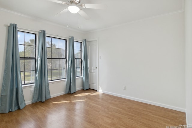 spare room featuring light wood-type flooring, ceiling fan, and crown molding