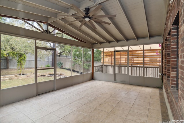 unfurnished sunroom with lofted ceiling with beams and ceiling fan