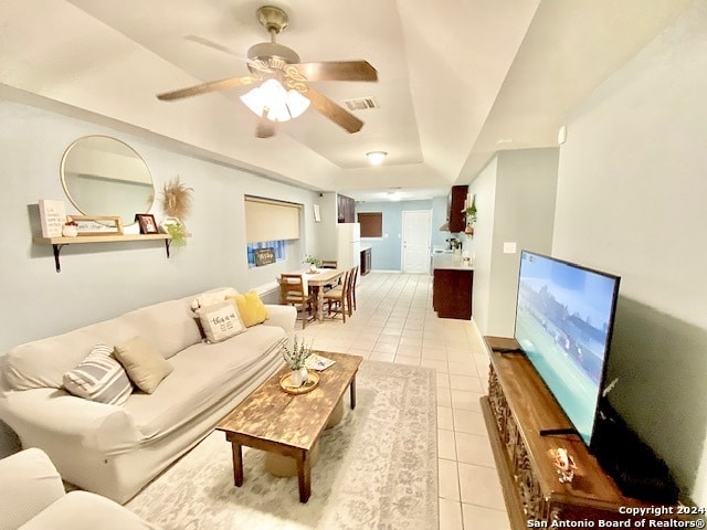 tiled living room featuring ceiling fan