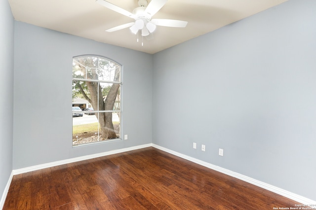 spare room with hardwood / wood-style floors and ceiling fan