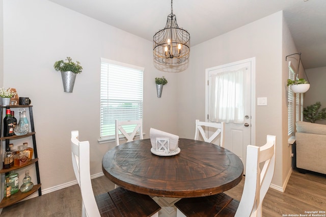 dining area featuring hardwood / wood-style floors and a chandelier