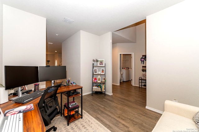 home office featuring washer / clothes dryer and hardwood / wood-style flooring