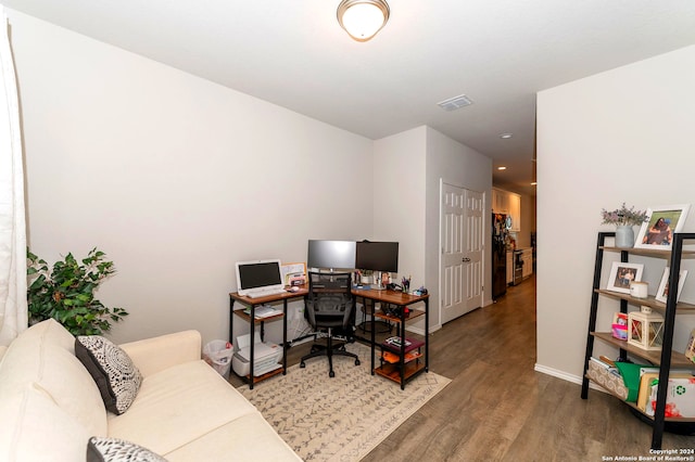 office with dark hardwood / wood-style floors