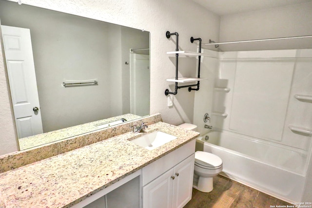 full bathroom with toilet, tub / shower combination, vanity, and wood-type flooring