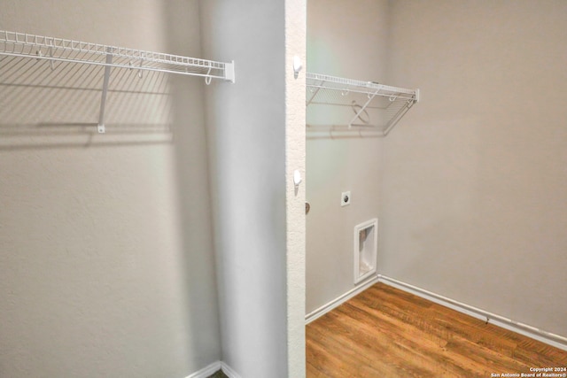 washroom with hardwood / wood-style floors and hookup for an electric dryer