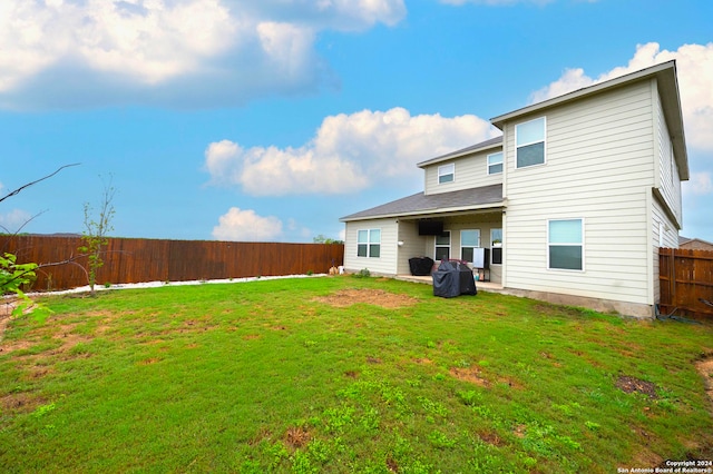 rear view of house with a lawn