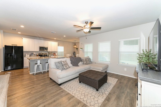 living room featuring hardwood / wood-style flooring and ceiling fan