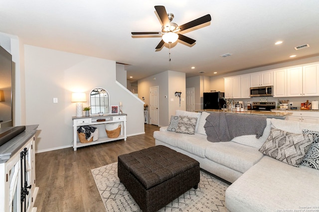 living room featuring hardwood / wood-style flooring and ceiling fan