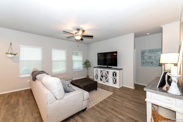 living room with dark wood-type flooring and ceiling fan