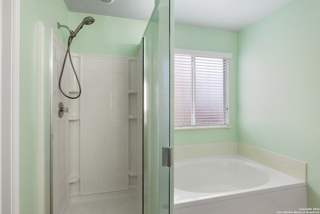 bathroom featuring separate shower and tub