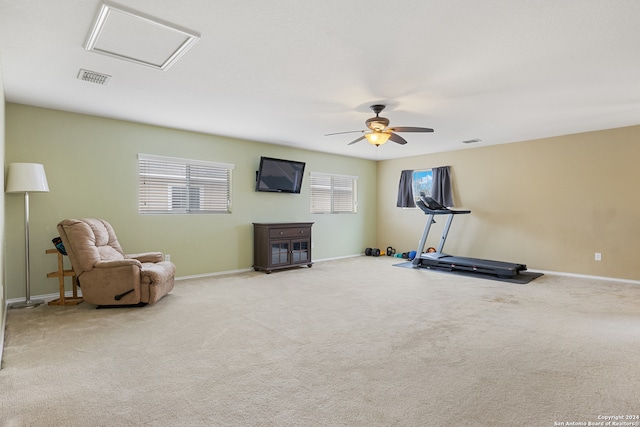 workout room featuring light carpet and ceiling fan