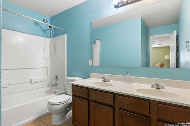 full bathroom featuring tile patterned floors, vanity, a textured ceiling, bathtub / shower combination, and toilet