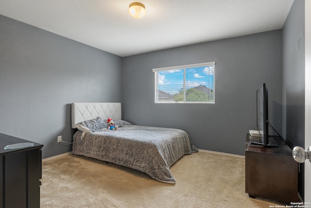 bedroom featuring light colored carpet