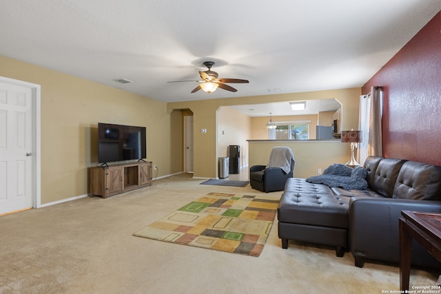 living room with light carpet and ceiling fan