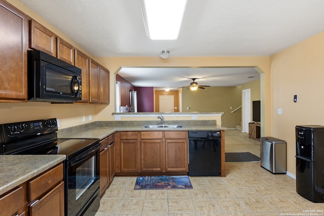 kitchen with black appliances, kitchen peninsula, sink, and ceiling fan