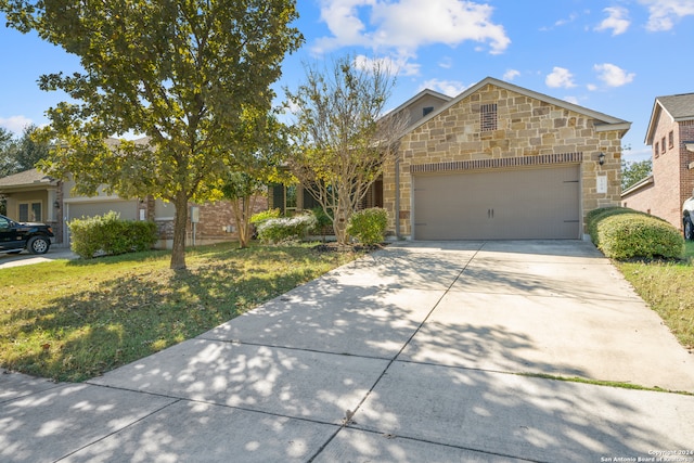 view of front of property featuring a garage and a front yard