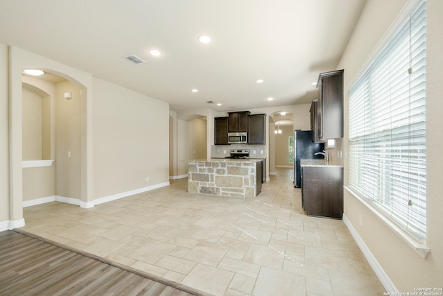 kitchen with decorative backsplash and appliances with stainless steel finishes