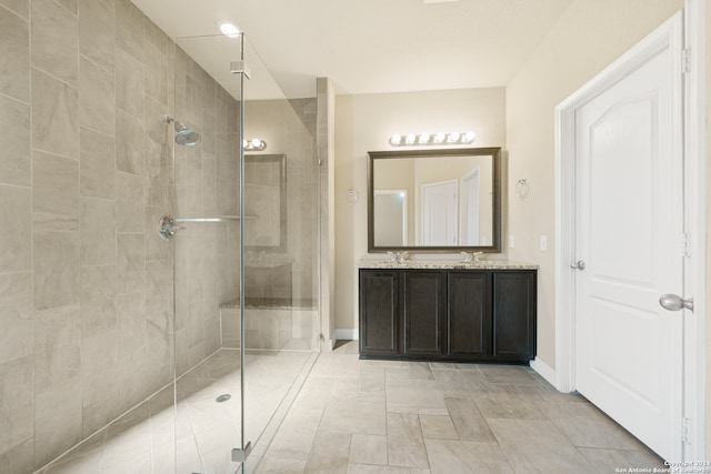 bathroom with vanity and a shower with shower door