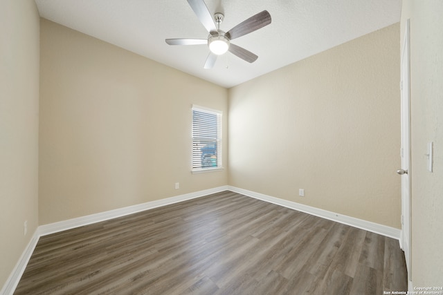 spare room featuring ceiling fan and dark hardwood / wood-style floors