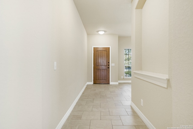 hall featuring light tile patterned flooring