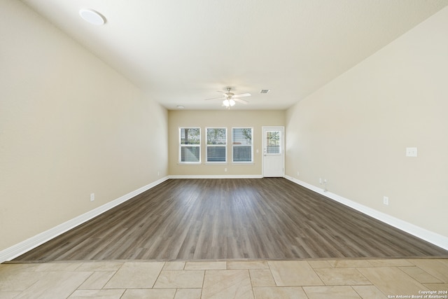 empty room featuring ceiling fan and light hardwood / wood-style flooring