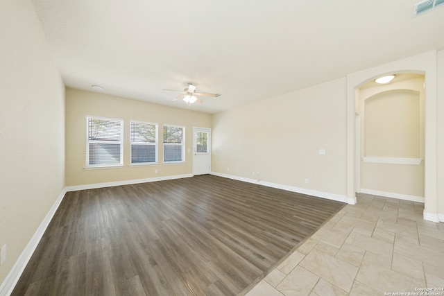 empty room featuring light wood-type flooring and ceiling fan