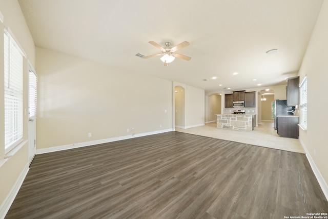 unfurnished living room with ceiling fan and light hardwood / wood-style floors