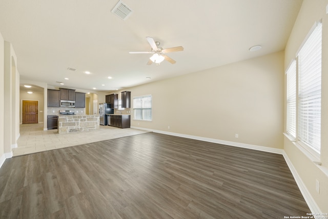 unfurnished living room with ceiling fan and light hardwood / wood-style floors