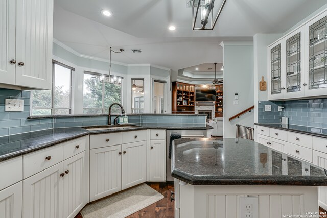 kitchen featuring hanging light fixtures, white cabinetry, sink, and a kitchen island