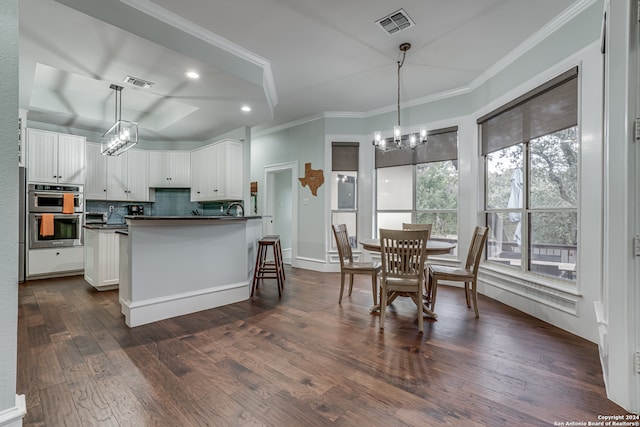 kitchen with white cabinetry, dark wood-type flooring, pendant lighting, and double oven