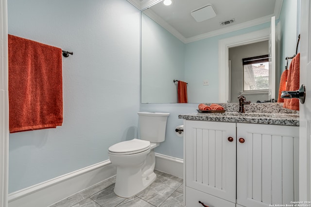 bathroom featuring toilet, vanity, and ornamental molding