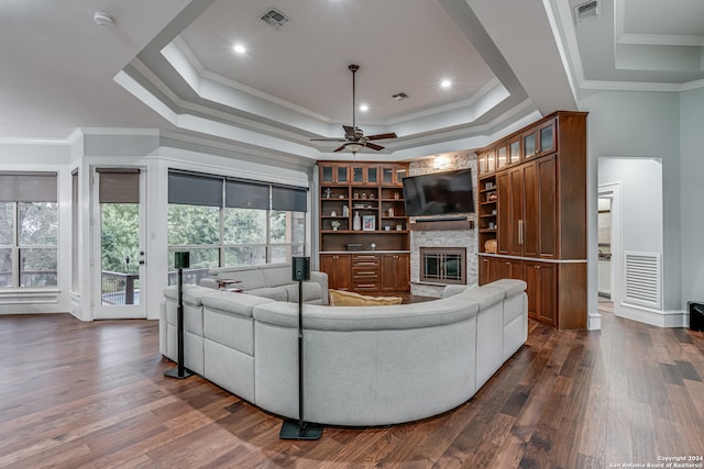 living room featuring ornamental molding, dark hardwood / wood-style floors, and a fireplace