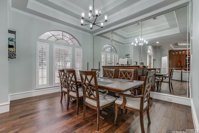 dining room with a chandelier, crown molding, dark hardwood / wood-style flooring, and a tray ceiling