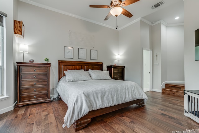 bedroom featuring dark hardwood / wood-style flooring, ornamental molding, and ceiling fan