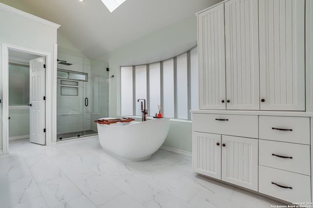 bathroom with shower with separate bathtub and vaulted ceiling