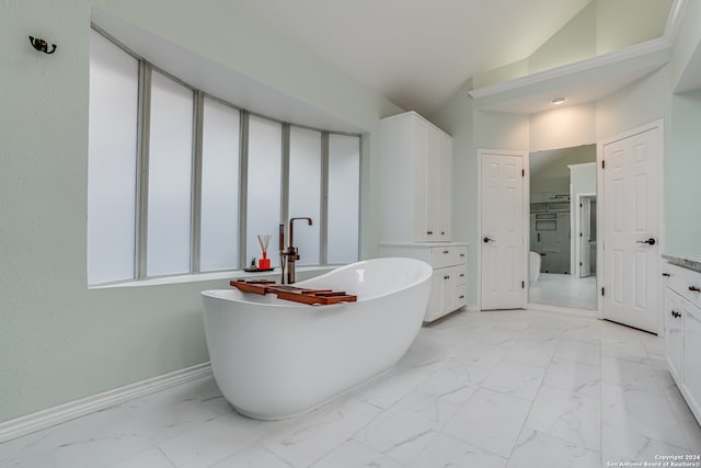 bathroom featuring vanity, shower with separate bathtub, and vaulted ceiling