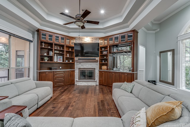 living room with dark hardwood / wood-style flooring, plenty of natural light, and crown molding