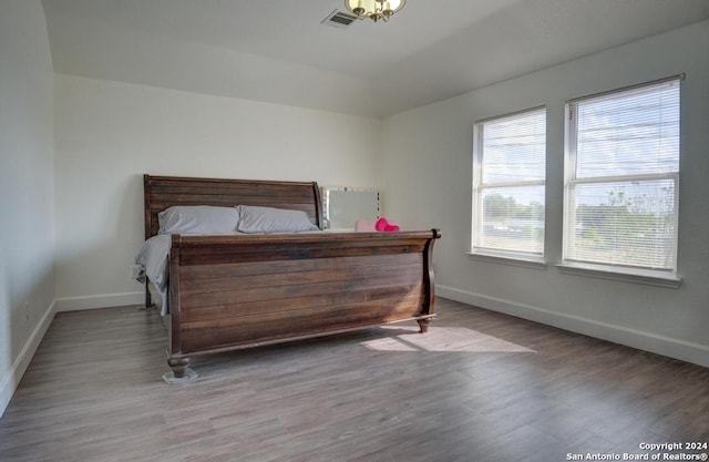 bedroom with hardwood / wood-style floors