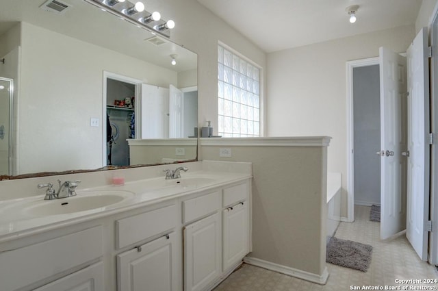 bathroom featuring a bath and vanity