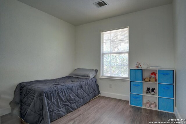 bedroom with wood-type flooring