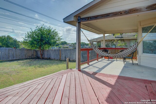 wooden terrace featuring a yard