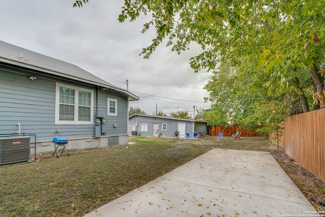 view of yard featuring central air condition unit and a patio area