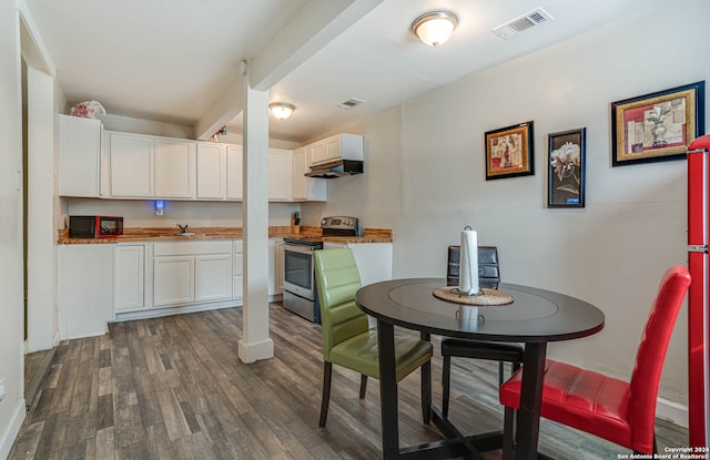 dining space with dark hardwood / wood-style floors