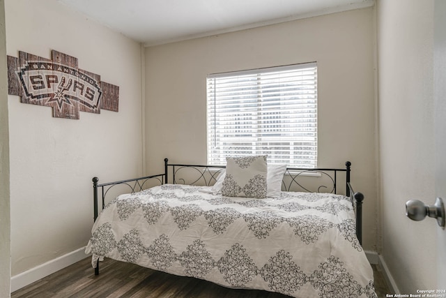 bedroom with dark hardwood / wood-style floors