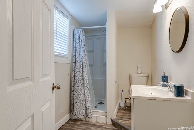 bathroom featuring toilet, vanity, hardwood / wood-style flooring, and a shower with shower curtain