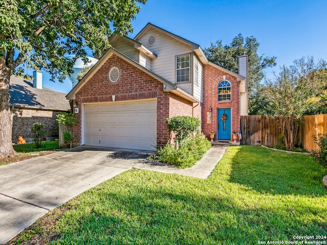 view of property with a front yard and a garage