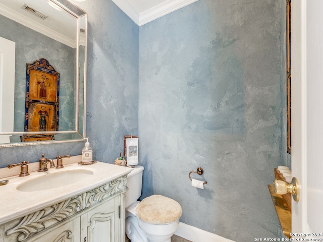 bathroom featuring vanity, toilet, and crown molding