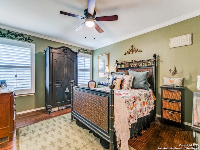 bedroom featuring multiple windows, hardwood / wood-style floors, and ceiling fan